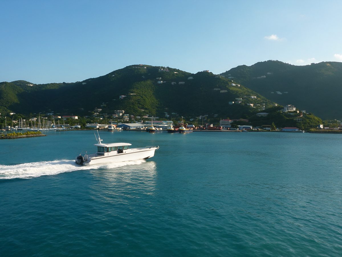 Water taxi crossing Road Harbour toward the Road Town waterfront below the green hills of Tortola, BVI